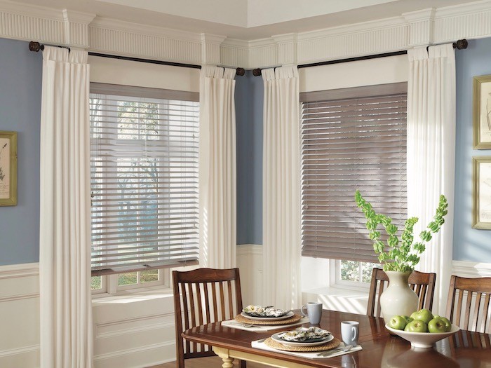 Farmhouse dinning area with white curtains and blinds 